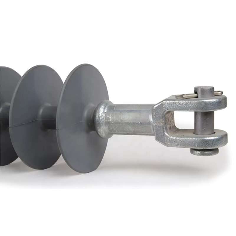 Close-up of composite dead-end suspension insulator showing clevis-tongue end fitting and silicone rubber shed design