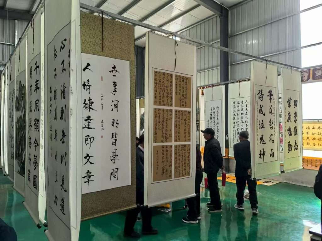 Company staff Chinese calligraphy culture activity in factory workshop, corporate culture construction event